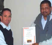 Branch chairman Raymond Cloete (r) handing the certificate of appreciation to Evan Dent.